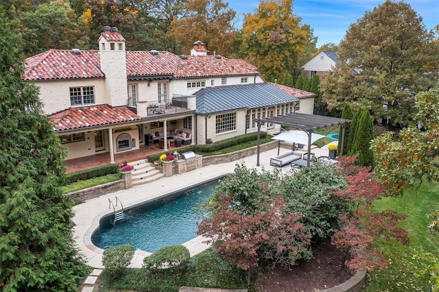 back of house with a pergola, a patio, and a balcony