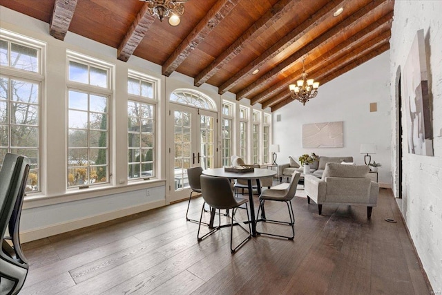 sunroom featuring french doors, a wealth of natural light, lofted ceiling with beams, wooden ceiling, and a notable chandelier