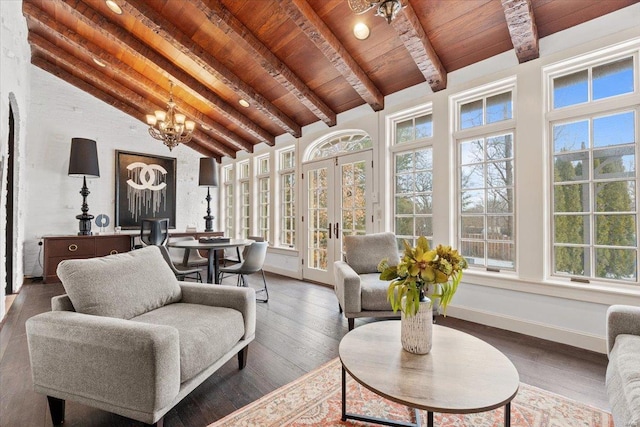 sunroom featuring french doors, an inviting chandelier, lofted ceiling with beams, and wooden ceiling