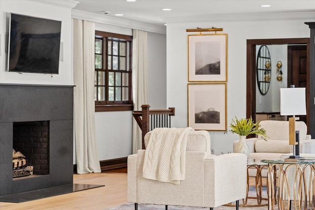 living room with crown molding and light hardwood / wood-style floors