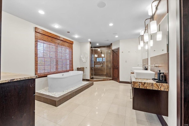 bathroom featuring vanity and separate shower and tub