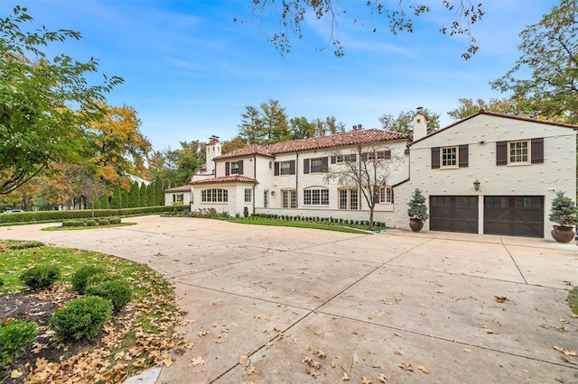 rear view of property featuring a garage