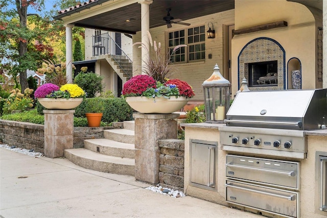 view of patio with an outdoor kitchen, a grill, a fireplace, and ceiling fan