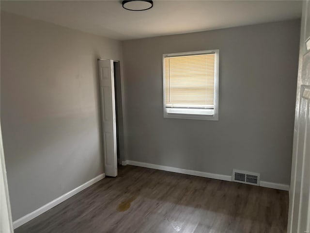 empty room featuring dark hardwood / wood-style floors