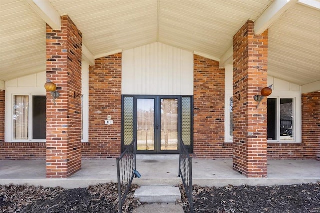 property entrance with french doors and brick siding