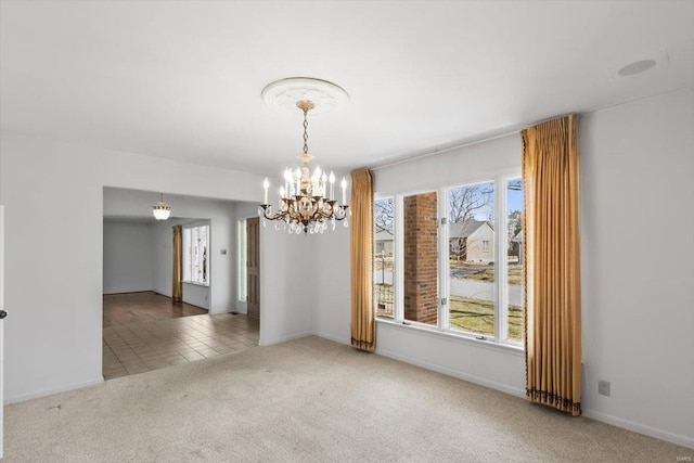 empty room with an inviting chandelier, carpet, baseboards, and tile patterned flooring