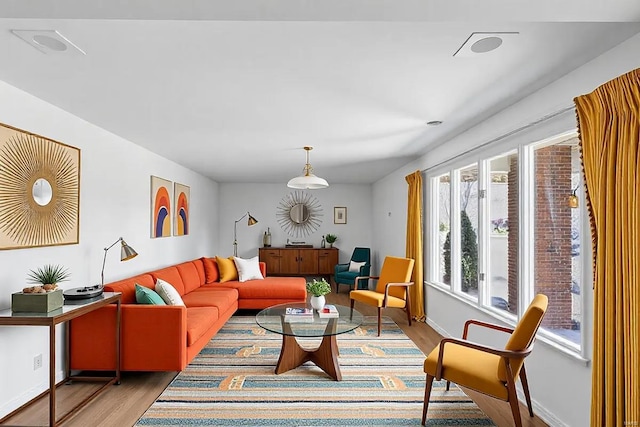 living area featuring baseboards and wood finished floors