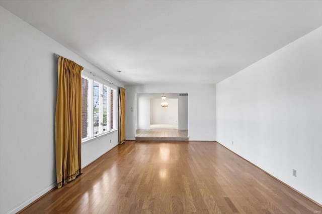 interior space featuring a notable chandelier and wood finished floors