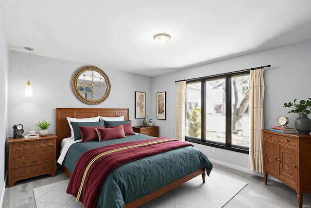 bedroom featuring baseboards and wood finished floors