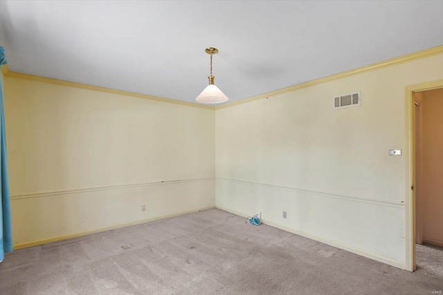 unfurnished room with baseboards, ornamental molding, visible vents, and light colored carpet