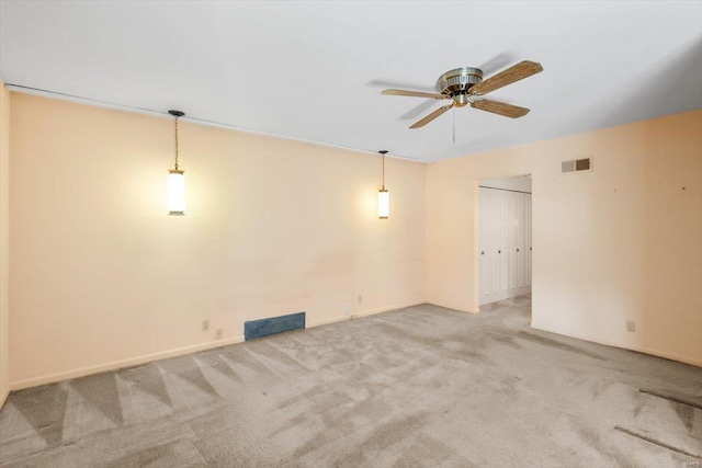 unfurnished room featuring a ceiling fan, visible vents, and light carpet