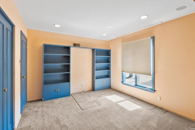 unfurnished bedroom featuring carpet floors, recessed lighting, and visible vents