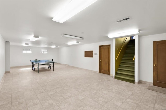 recreation room with baseboards, visible vents, and light floors