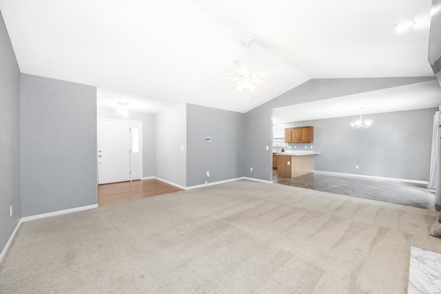 unfurnished living room with light carpet, ceiling fan with notable chandelier, and lofted ceiling