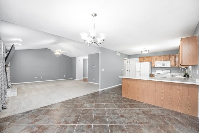 kitchen with white appliances, ceiling fan with notable chandelier, sink, decorative light fixtures, and kitchen peninsula