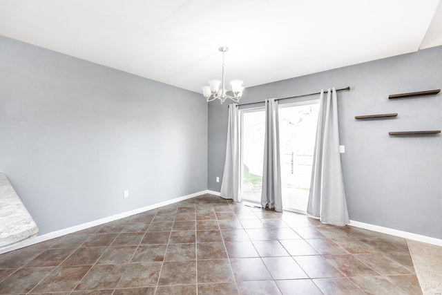 unfurnished room featuring an inviting chandelier