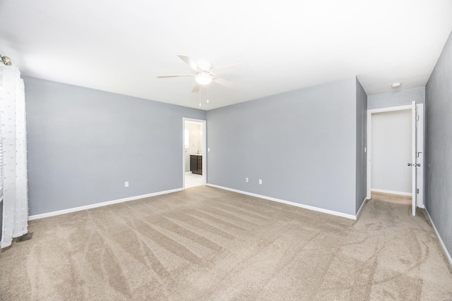 unfurnished room with ceiling fan and light carpet