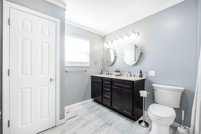 bathroom with vanity, toilet, and crown molding