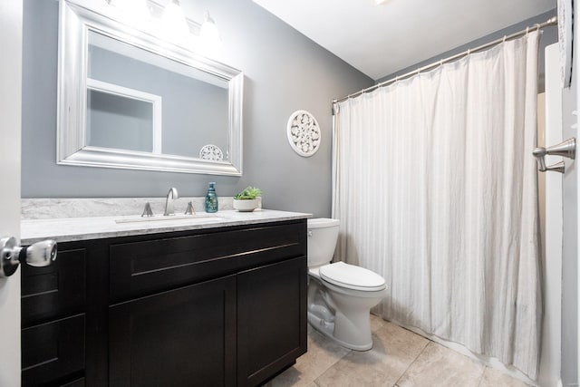 bathroom with tile patterned floors, vanity, and toilet