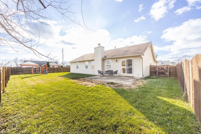 rear view of house featuring a lawn and a patio