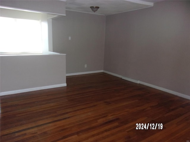 spare room with dark hardwood / wood-style floors