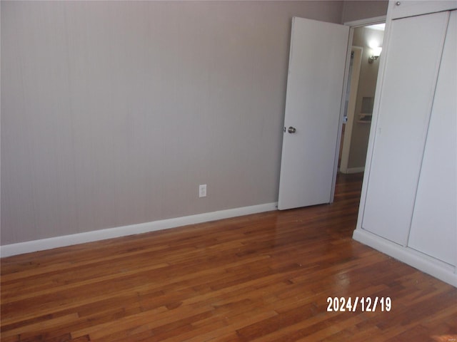 unfurnished bedroom with dark wood-type flooring