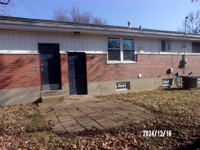 back of house featuring cooling unit