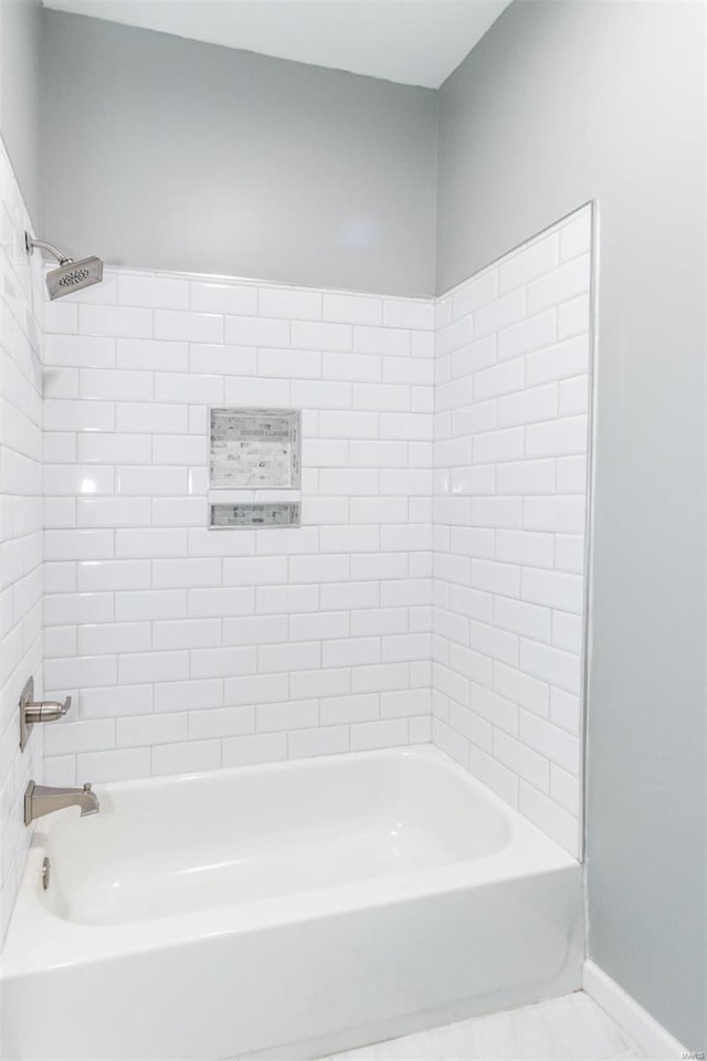 bathroom with tile patterned flooring and bathing tub / shower combination