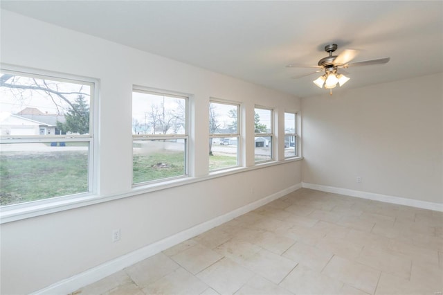 spare room with plenty of natural light and ceiling fan