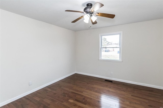 empty room featuring ceiling fan and dark hardwood / wood-style flooring