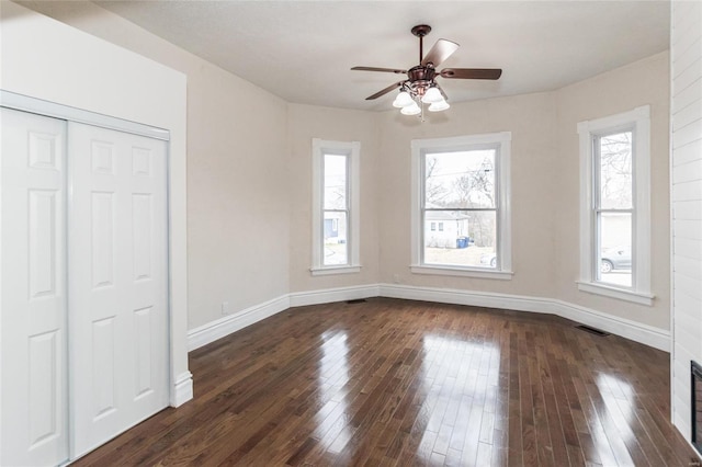 interior space with dark hardwood / wood-style flooring and ceiling fan