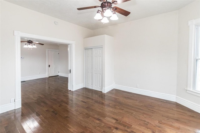 spare room featuring ceiling fan and dark wood-type flooring