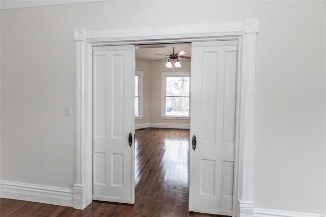 hallway with dark hardwood / wood-style floors