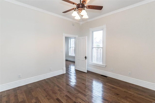 empty room featuring dark hardwood / wood-style flooring, ceiling fan, and crown molding