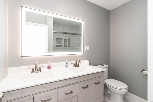 bathroom featuring walk in shower, vanity, and toilet