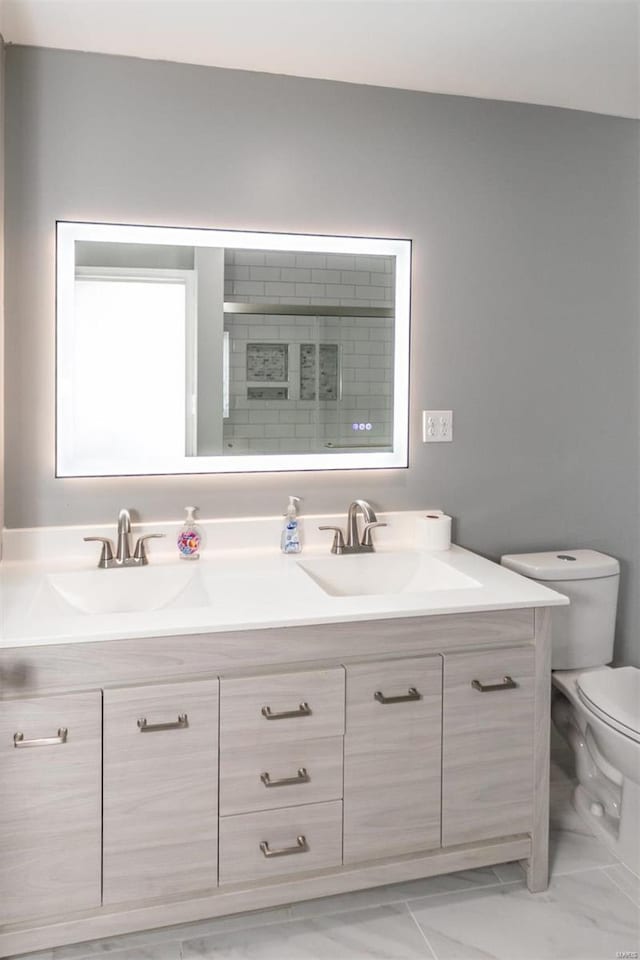 bathroom with vanity, toilet, and an enclosed shower