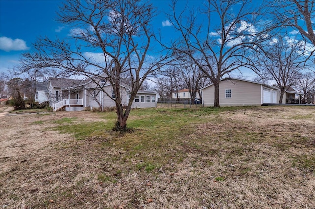 view of yard with a porch and a garage