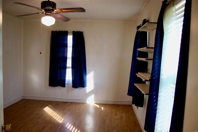 unfurnished room featuring hardwood / wood-style floors and ceiling fan