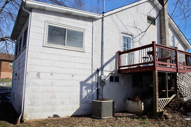 back of property with a wooden deck and central air condition unit