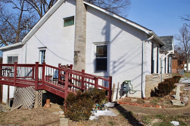 rear view of house featuring a wooden deck