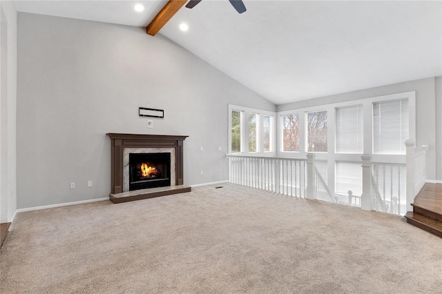 unfurnished living room featuring vaulted ceiling with beams, ceiling fan, carpet floors, and a high end fireplace