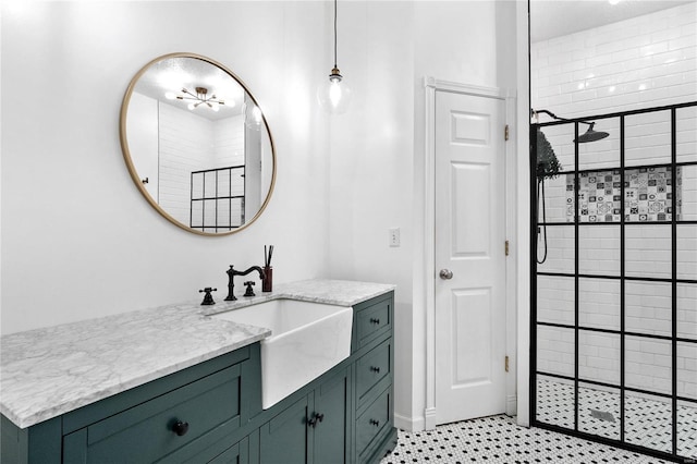 bathroom featuring a tile shower and vanity