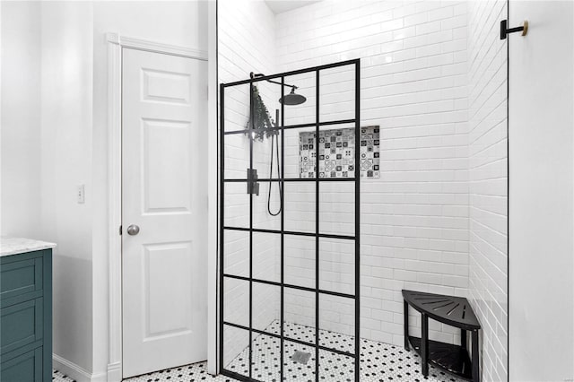 bathroom with vanity and a tile shower