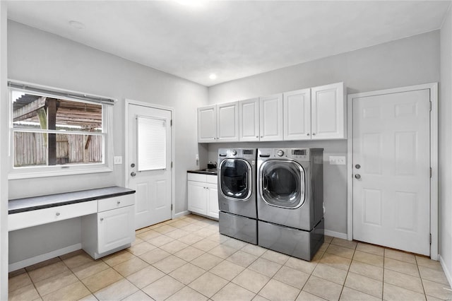 laundry area featuring light tile patterned floors, cabinets, and independent washer and dryer