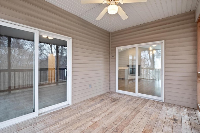 unfurnished sunroom featuring ceiling fan and wood ceiling