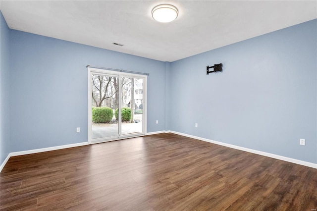 spare room with dark hardwood / wood-style floors