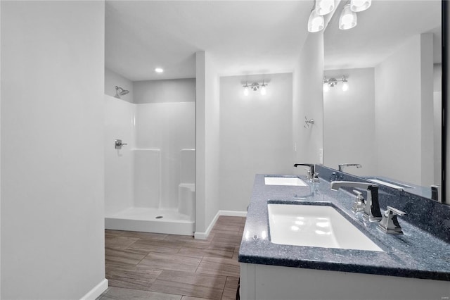 bathroom with a shower and vanity