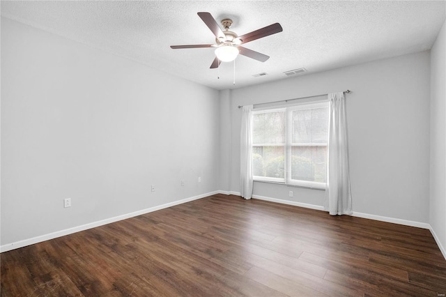 unfurnished room with a textured ceiling, ceiling fan, and dark wood-type flooring