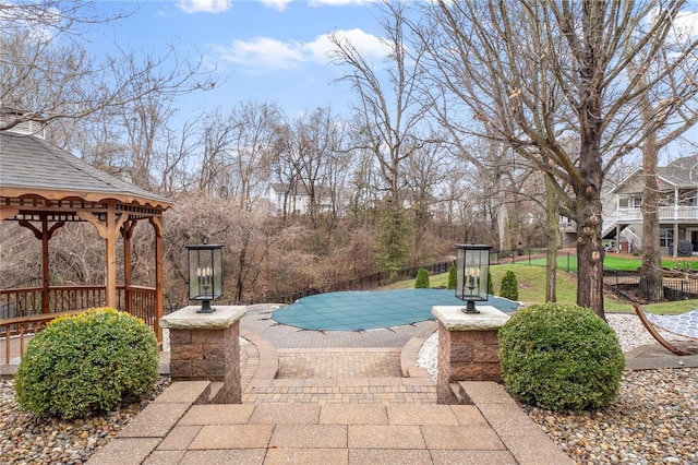 view of swimming pool with a gazebo and a patio area