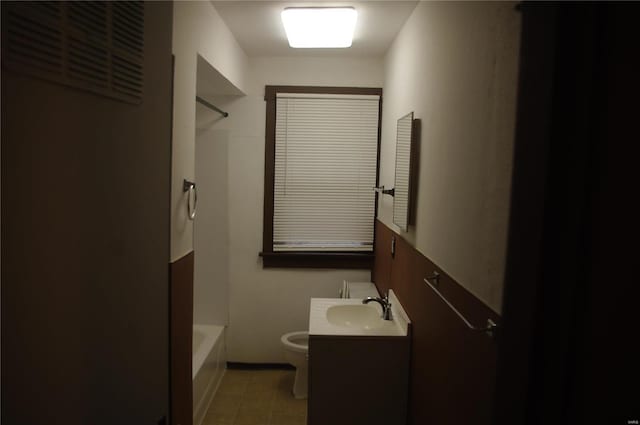 full bathroom featuring washtub / shower combination, vanity, and toilet